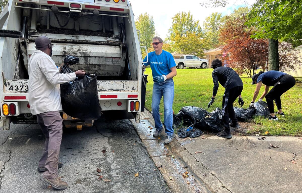 Volunteers pick up plastic bags full of yard waste in Jonesboro.