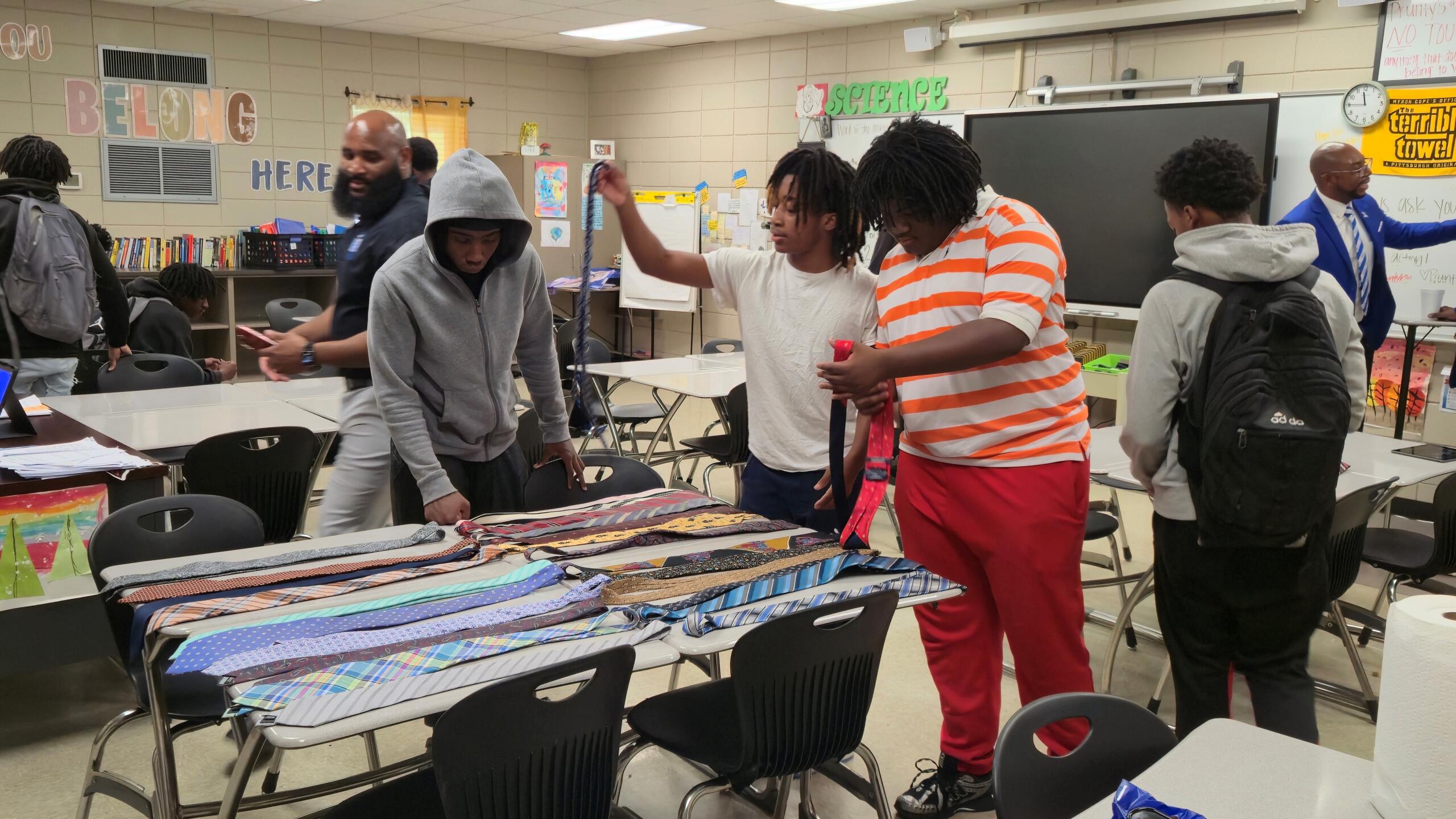 Students examine various ties.