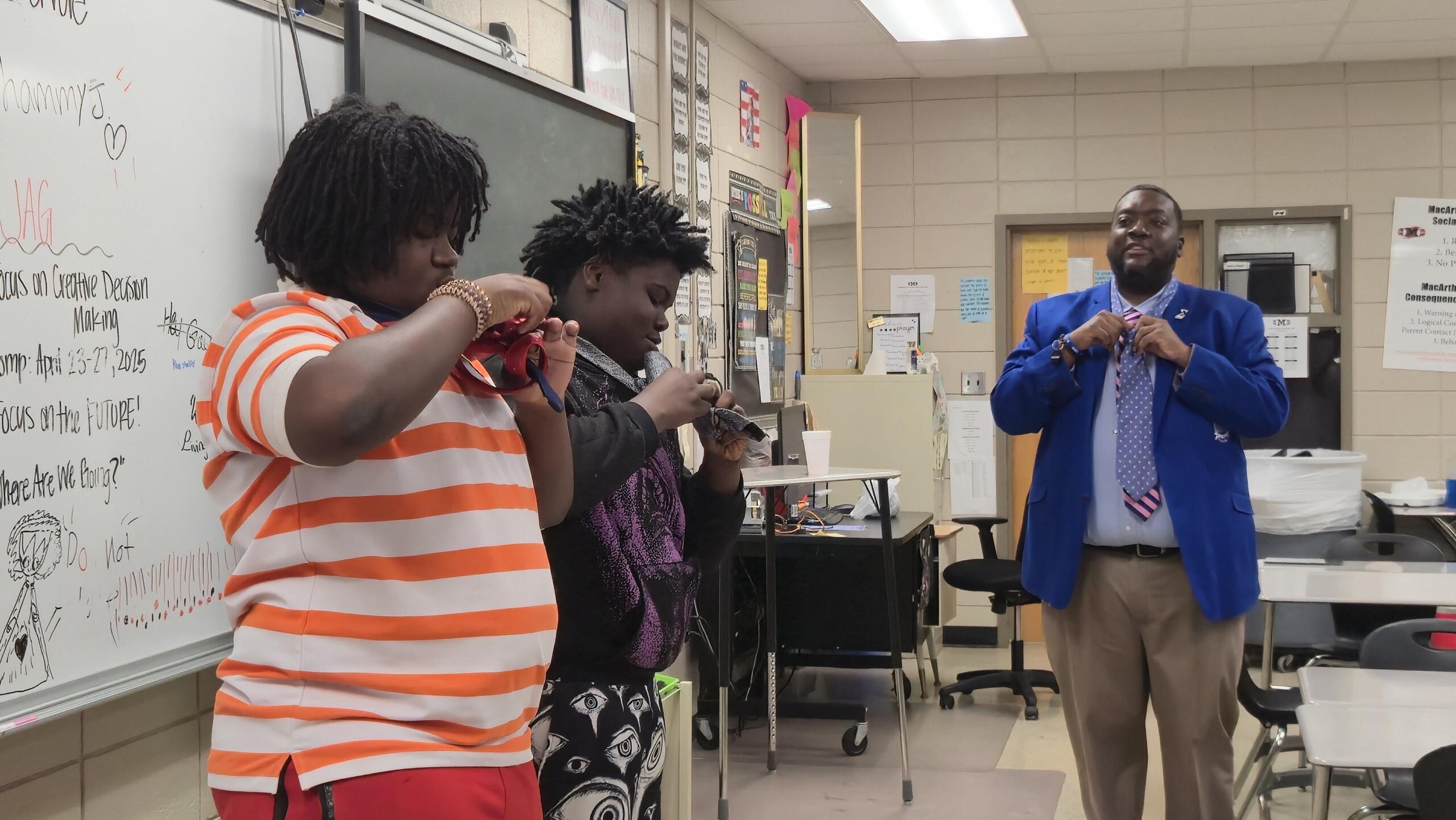 Two students trying to tie their necktie the fastest during a competition