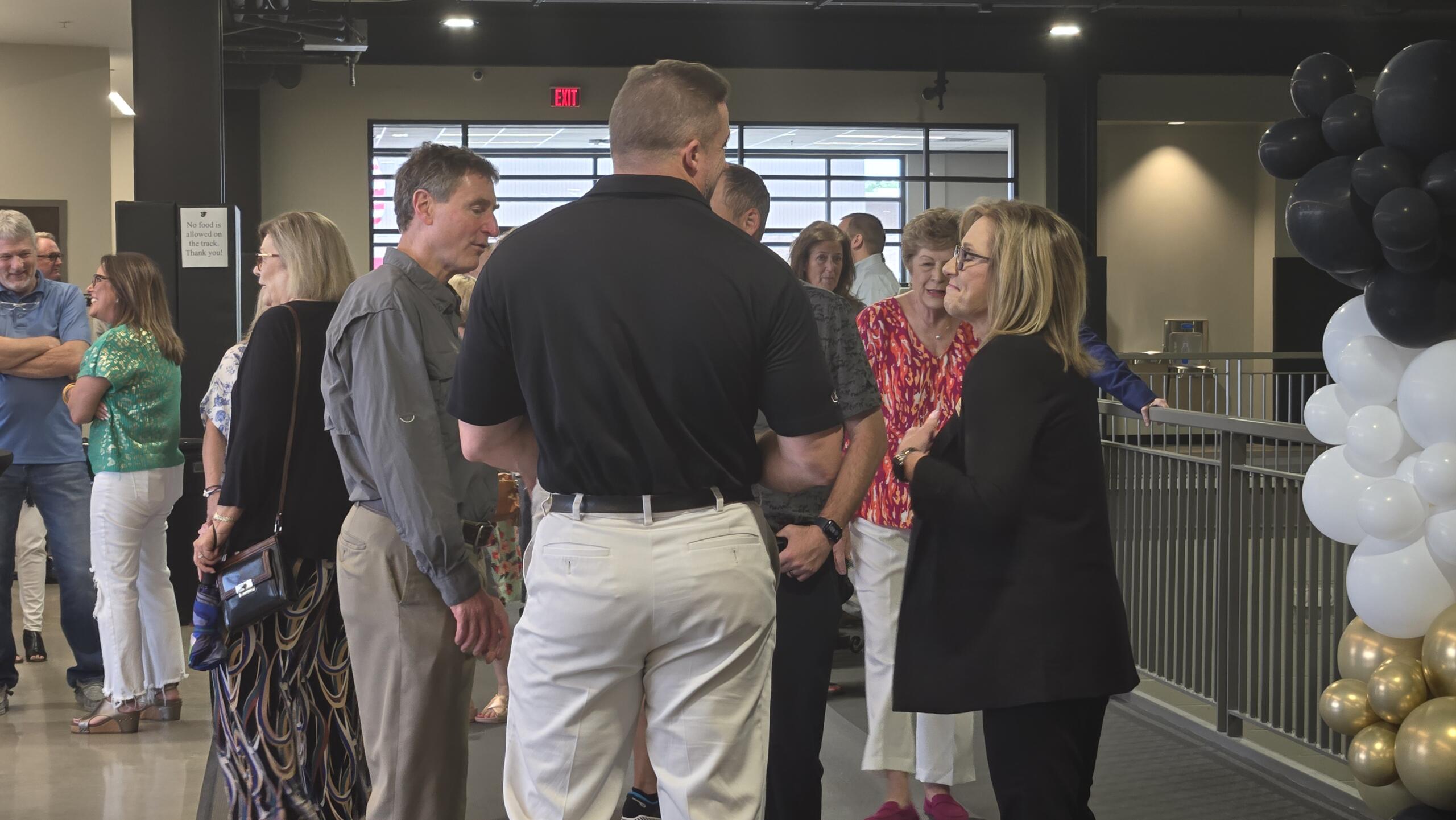 Wilbanks (far right) speaks with retirement party attendees.