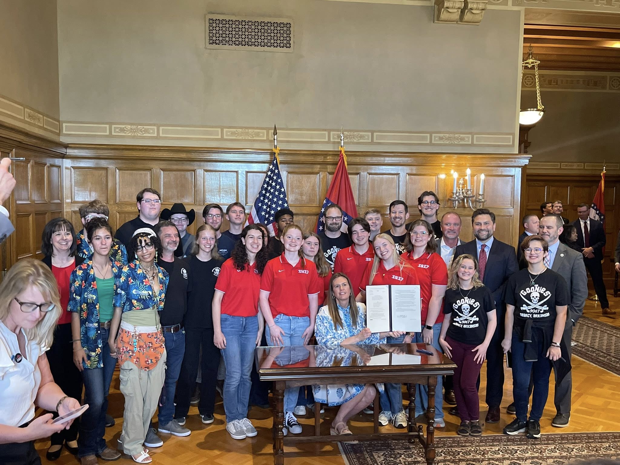 Various robotics teams join Arkansas Gov. Sarah Huckabee Sanders for the signing of Act 472. 
