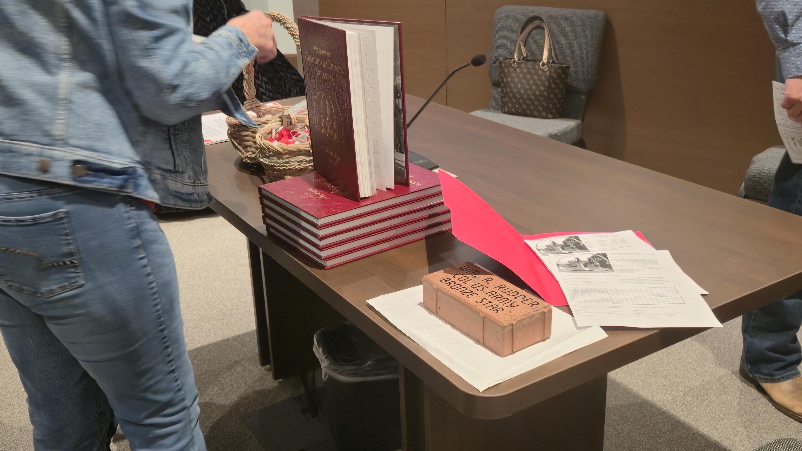 One of the bricks presented during the ceremony, and the book containing information about Craighead County veterans.
