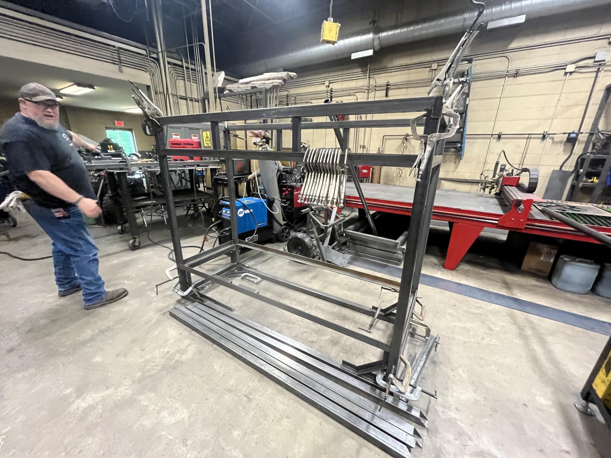 Henry Laxton shows off a bunk in the process of being built.