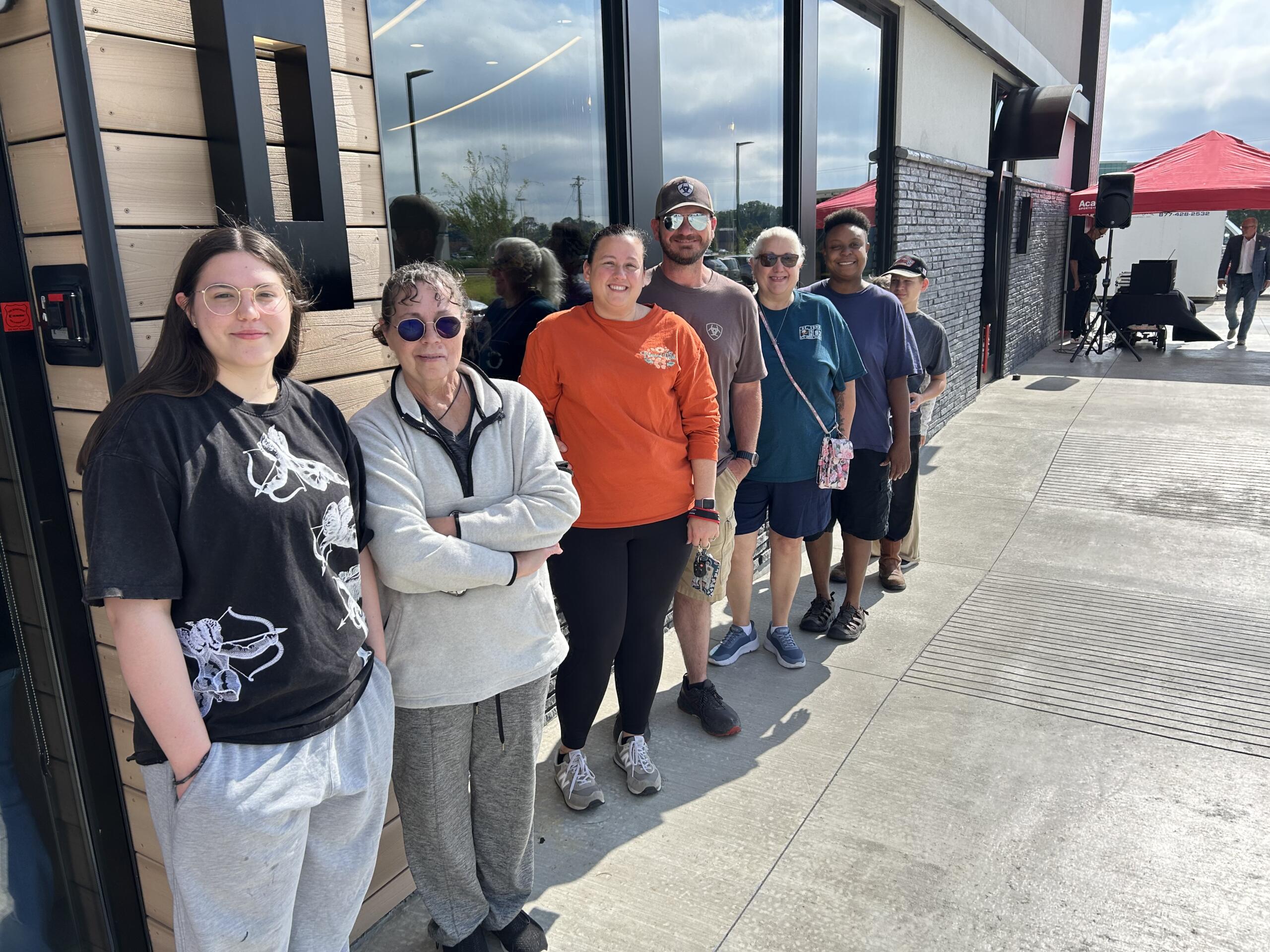 People wait outside Panda Express during the grand opening. 