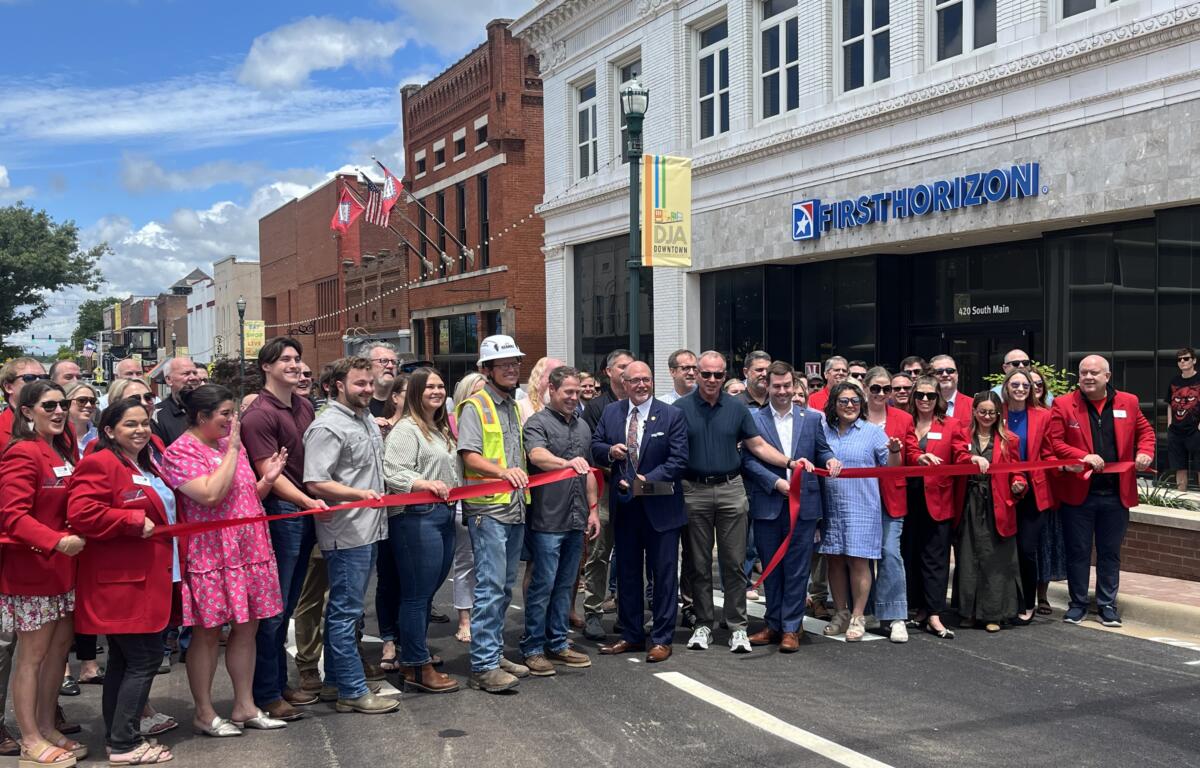 City officials, downtown business owners and Nabholz officials cut the ribbon, reopening Main Street.