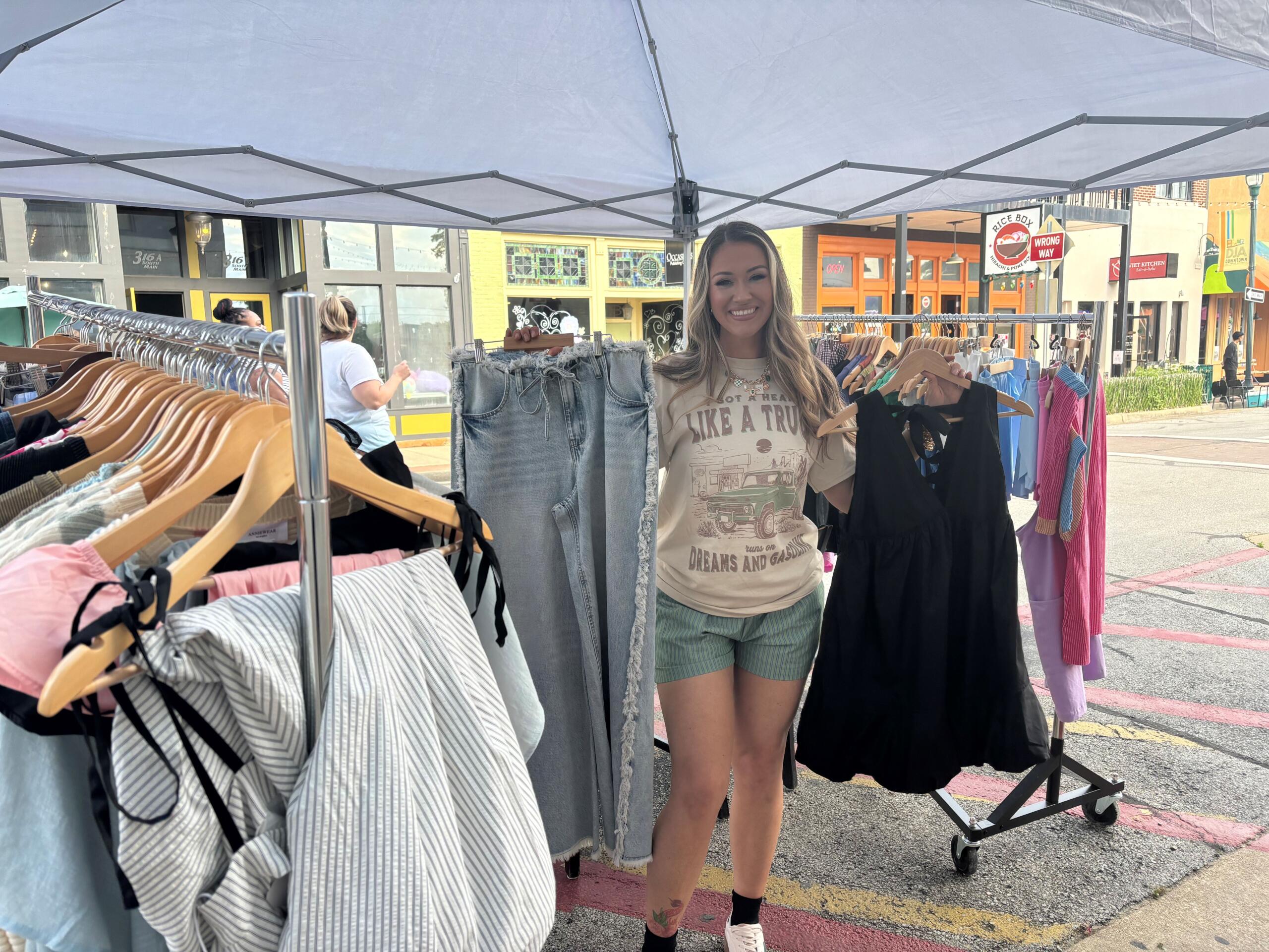 Owner Rebecca Richmond posing with merchandise during the Meet Me on Main event on May 8. 