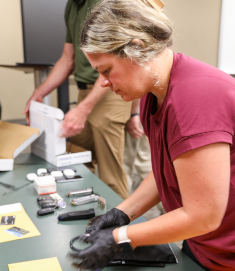 Jonesboro Police investigator sorts through items recovered during investigation of weekend break-ins