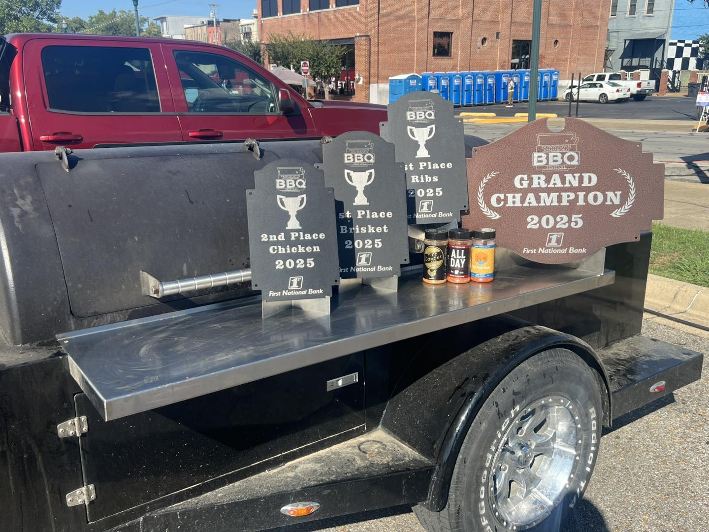 The Bad Dog BBQ team displays their awards, including Grand Champion from the Downtown Jonesboro BBQ Contest