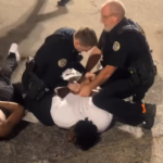 Jonesboro police detain a person at an apparent street fight at Cate and Church Streets in Jonesboro Friday night