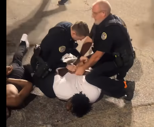 Jonesboro police detain a person at an apparent street fight at Cate and Church Streets in Jonesboro Friday night
