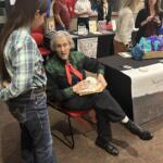 Author-speaker and animal-science visionary Temple Grandin signs copies of her book "The Way I See It" after speaking at Jonesboro conference