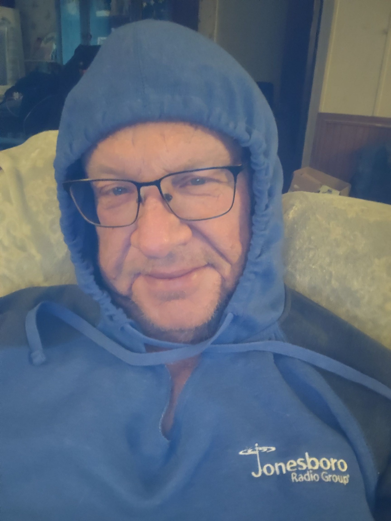 man in blue hoodie with glasses