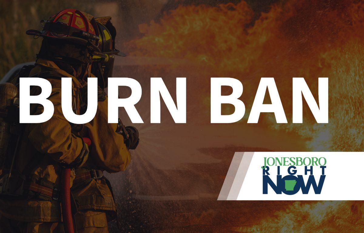 image of fireman putting out fire with Burn Ban in foreground