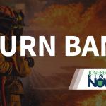 image of fireman putting out fire with Burn Ban in foreground