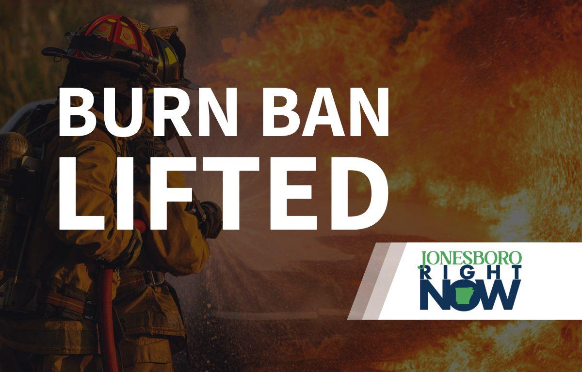 image of fireman putting out fire with Burn Ban Lifted in foreground