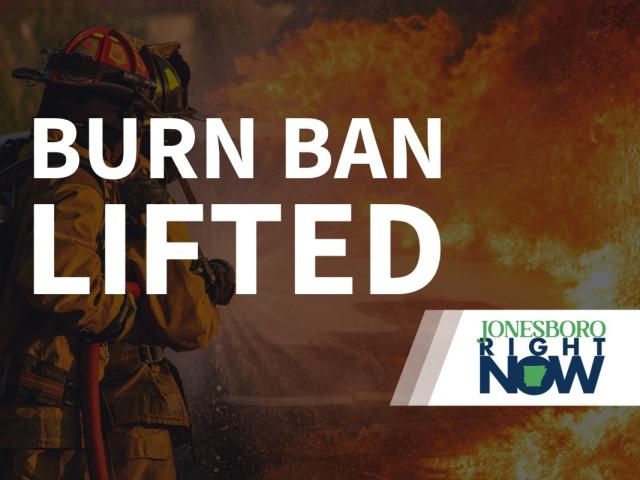 image of fireman putting out fire with Burn Ban Lifted in foreground