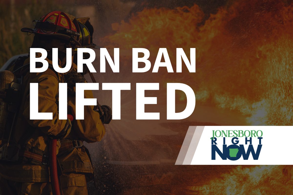 image of fireman putting out fire with Burn Ban Lifted in foreground