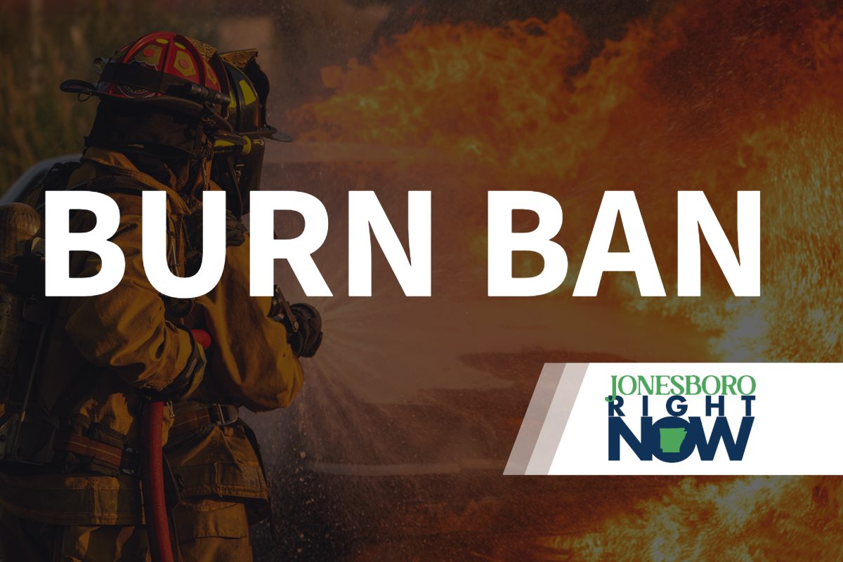 image of fireman putting out fire with Burn Ban in foreground