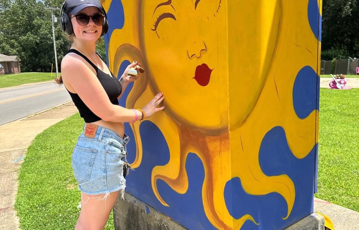 zoey garner painting a traffic control cabinet