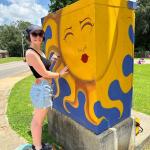 zoey garner painting a traffic control cabinet