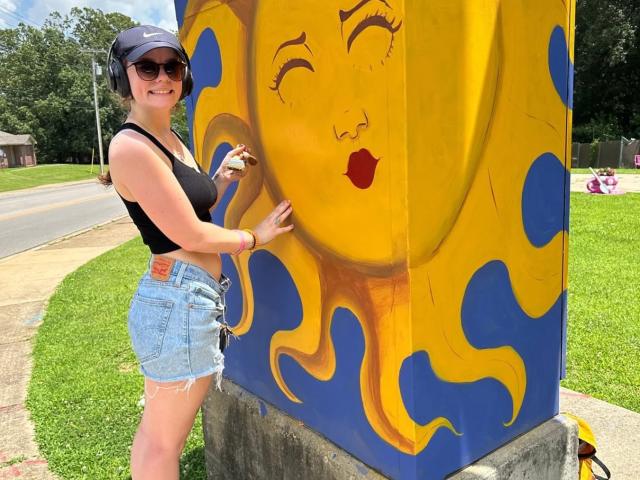 zoey garner painting a traffic control cabinet