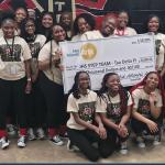 group of young women holding check presented to JHS step team