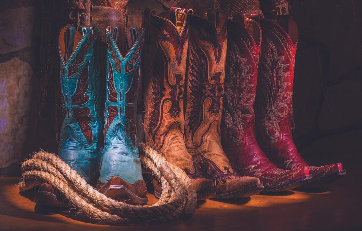 three cowboy boot sets in a row, blue tan and pink
