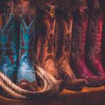 three cowboy boot sets in a row, blue tan and pink