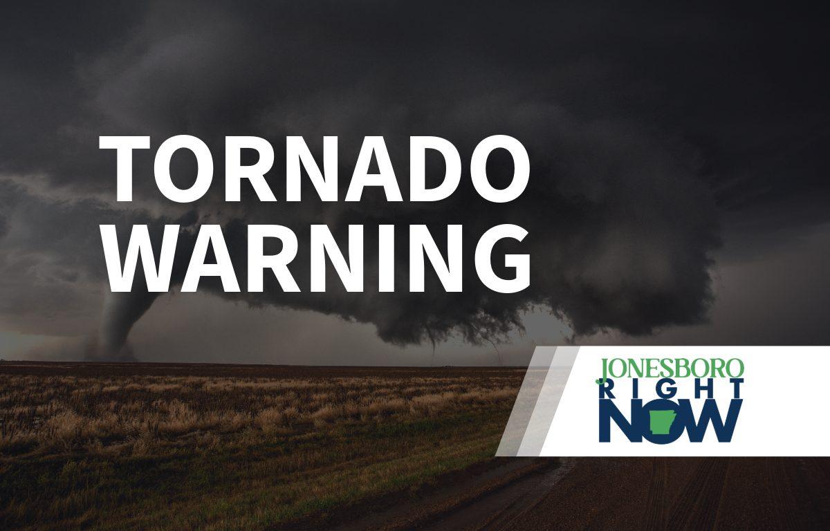 tornado on flat land with tornado warning in foreground