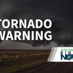 tornado on flat land with tornado warning in foreground