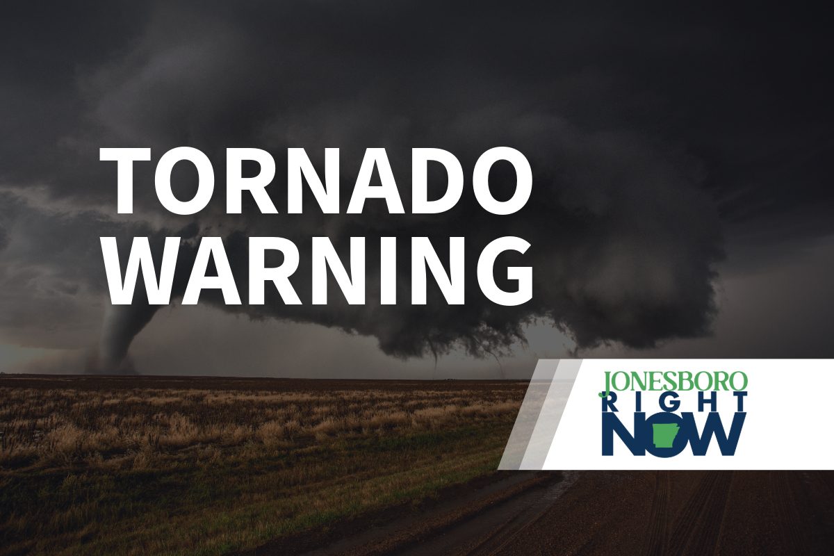 tornado on flat land with tornado warning in foreground