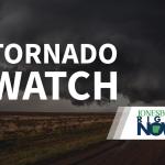 tornado on flat land with tornado watch text in foreground