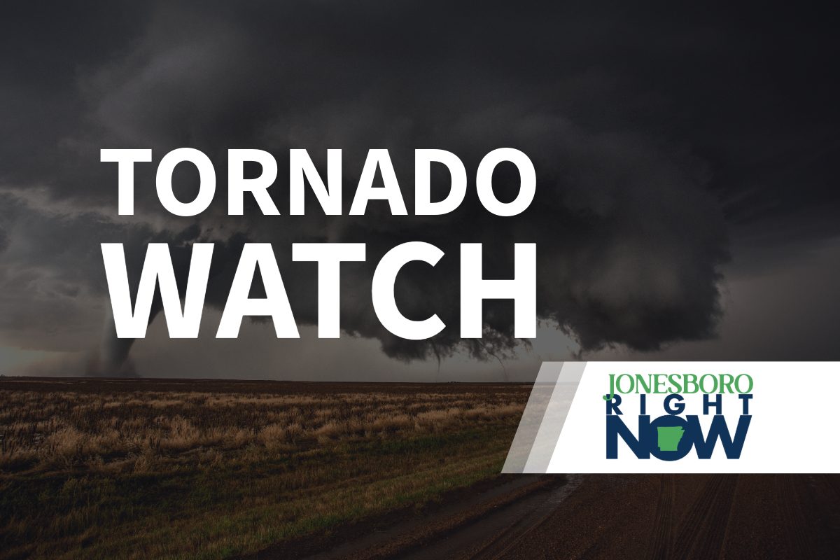 tornado on flat land with tornado watch text in foreground