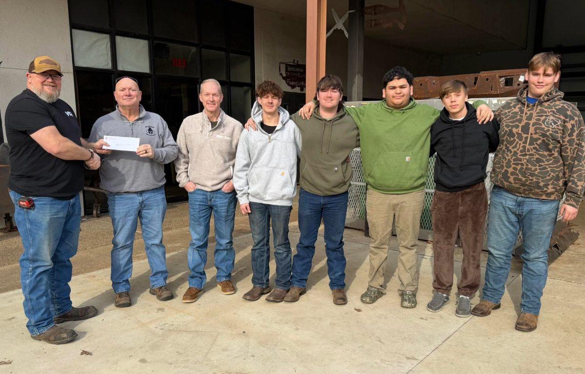 8 men ranging in age pose in a semi circle