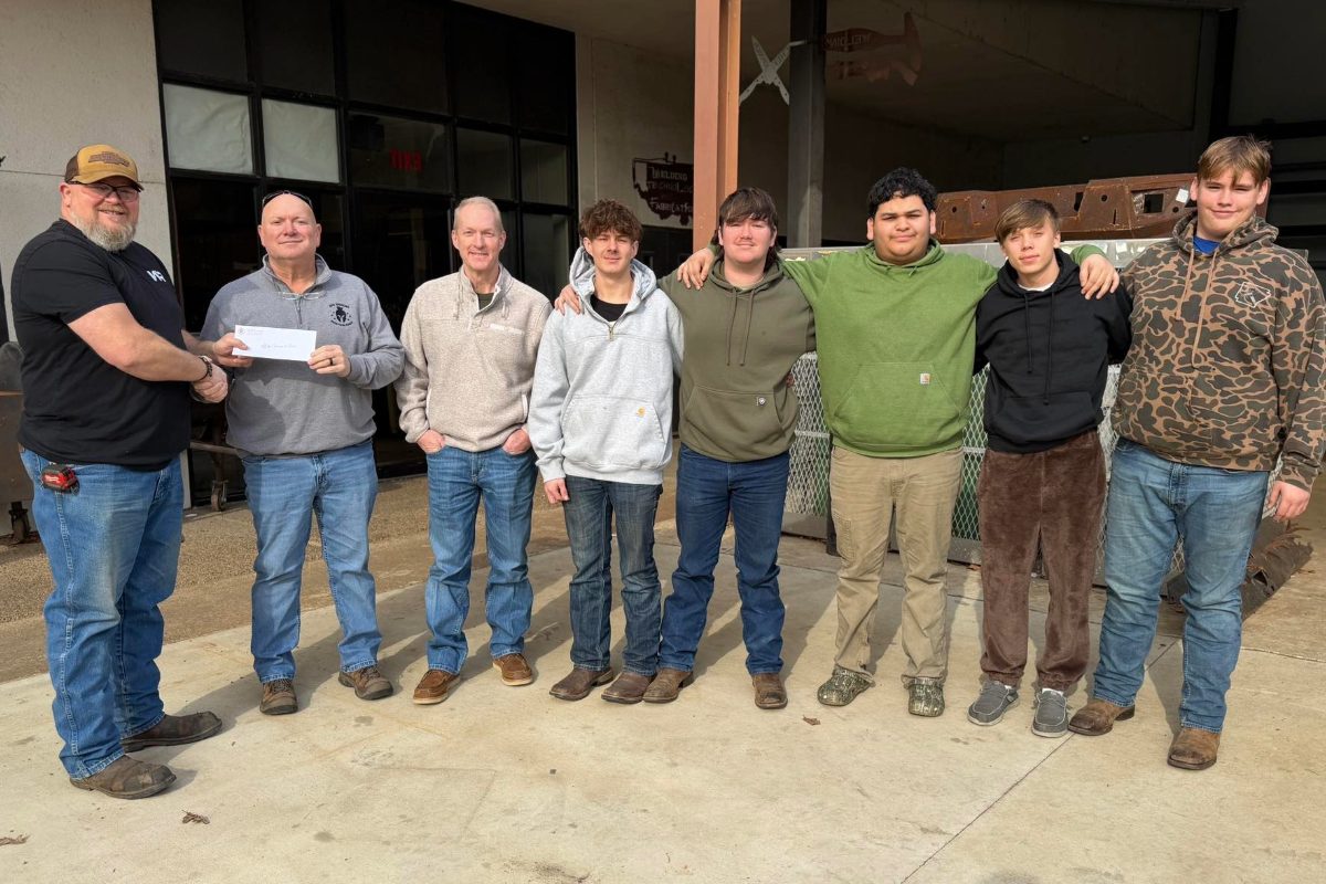 8 men ranging in age pose in a semi circle