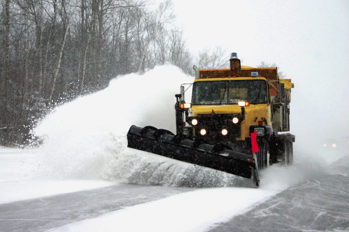 yellow snow plow clearing roads