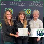 three women representing Hope Found hold a certificate