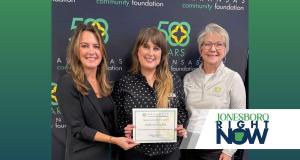 three women representing Hope Found hold a certificate