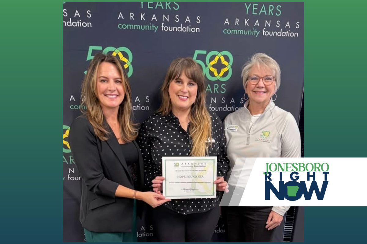 three women representing Hope Found hold a certificate