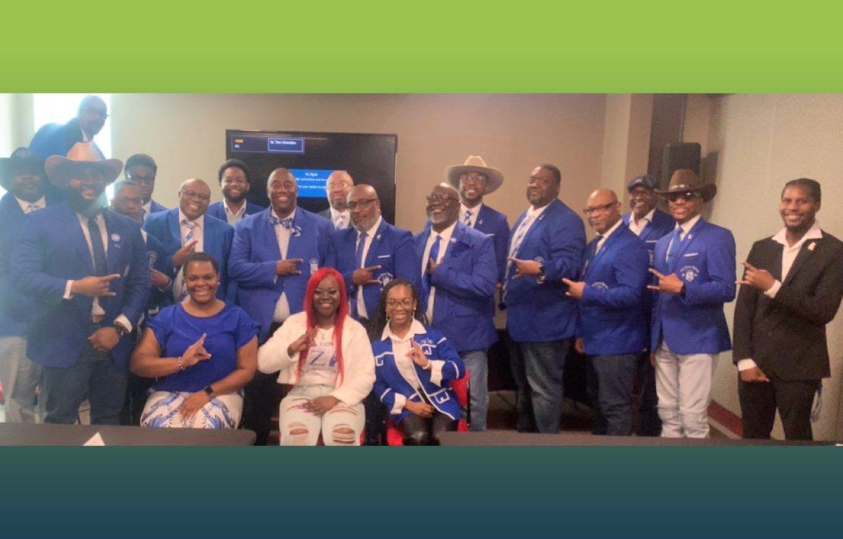 group photo of fraternity dressed in blue