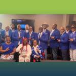 group photo of fraternity dressed in blue