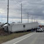 two semi trucks in ditch