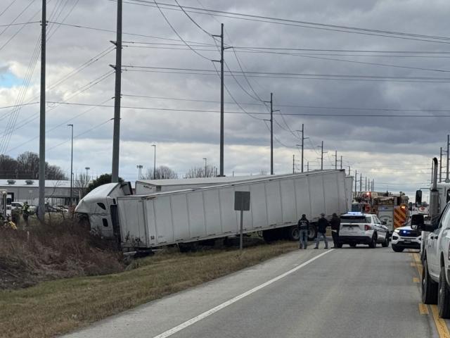 two semi trucks in ditch