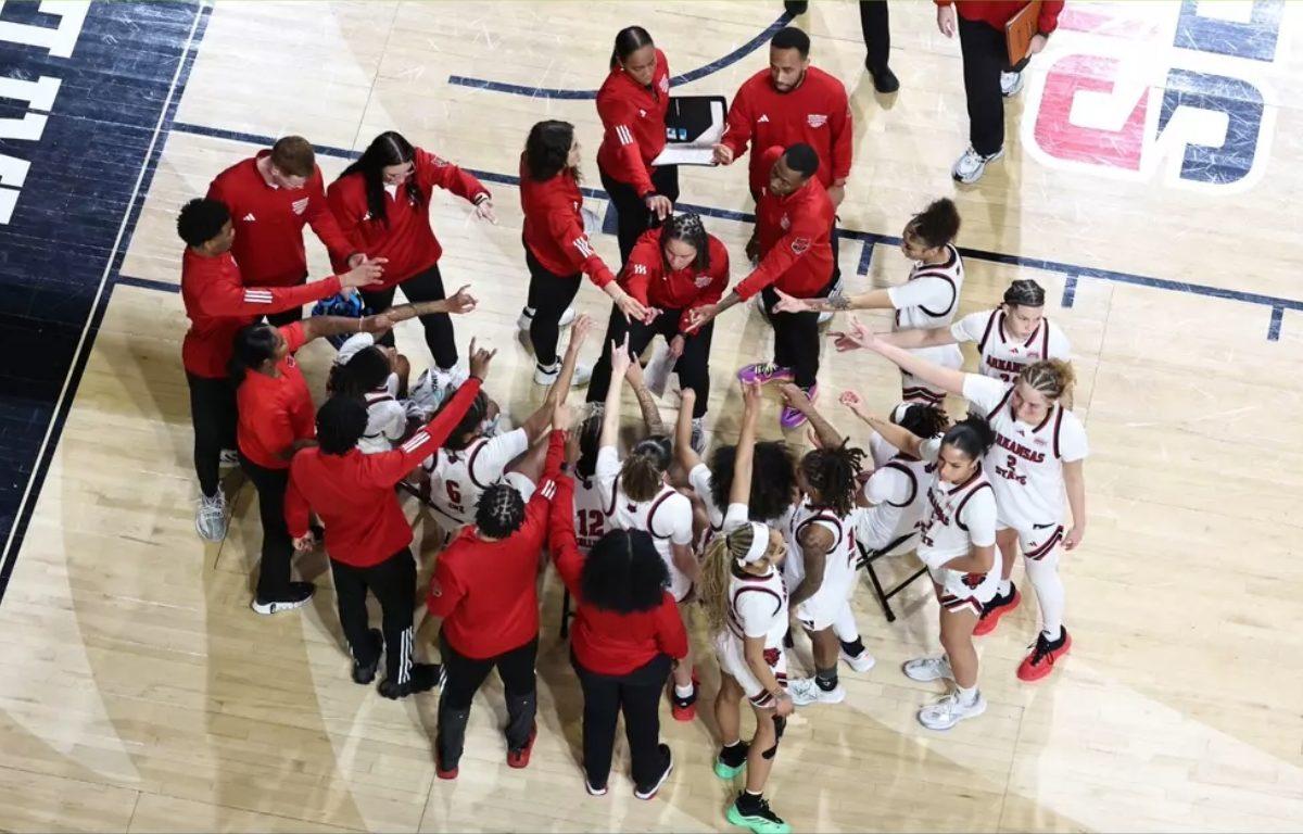 a-state womens basketball team in circle huddle