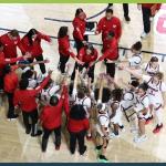 a-state womens basketball team in circle huddle