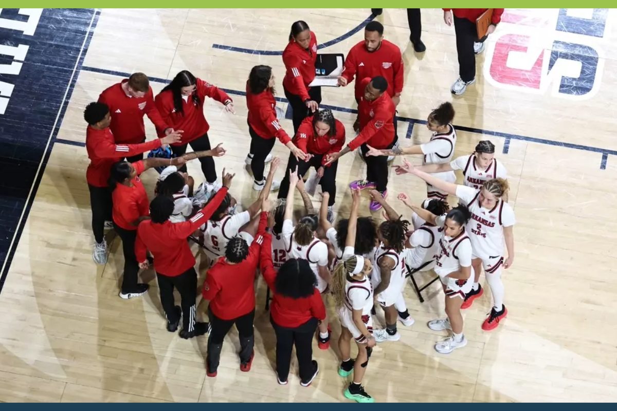 a-state womens basketball team in circle huddle