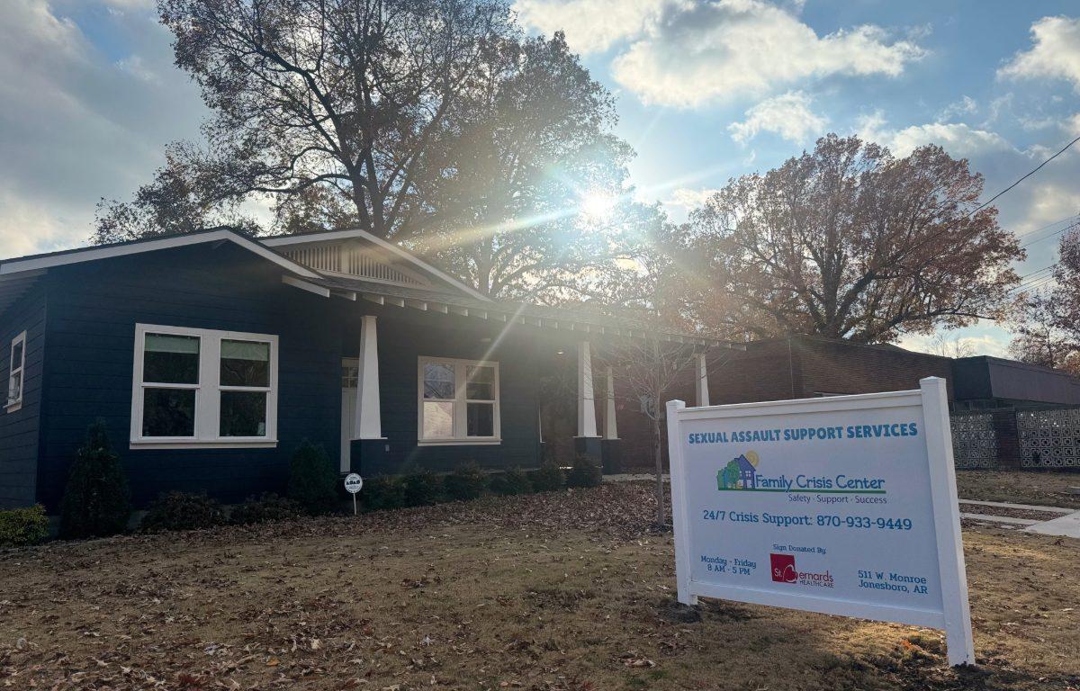 front of building with sign for Family Crisis Center in yard