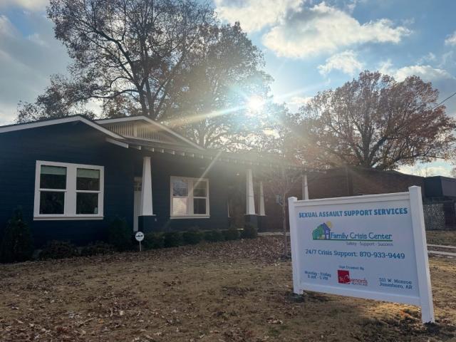 front of building with sign for Family Crisis Center in yard