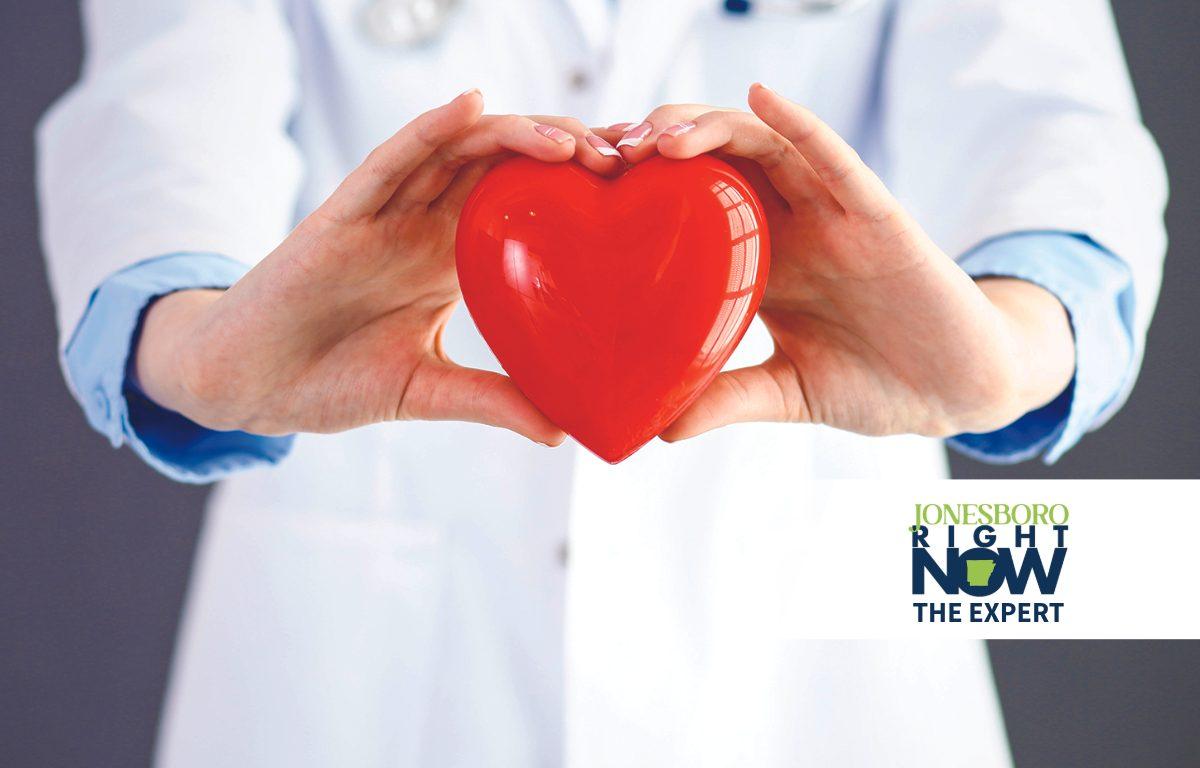 doctor holding plastic heart