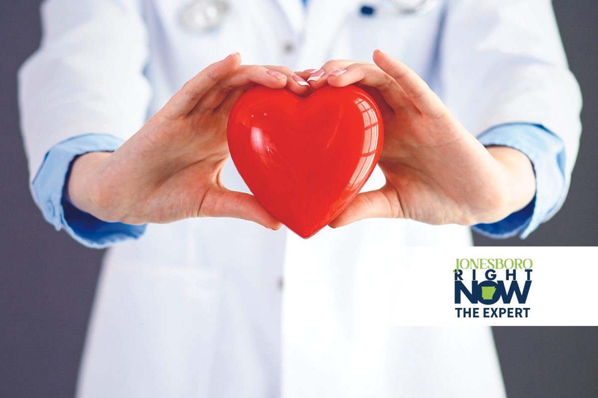 doctor holding plastic heart